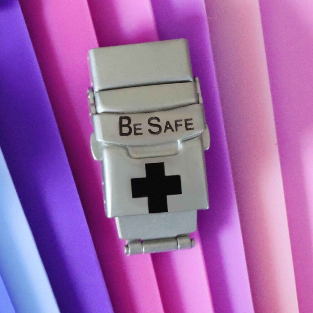 be safe clasp and faceplate on colored background